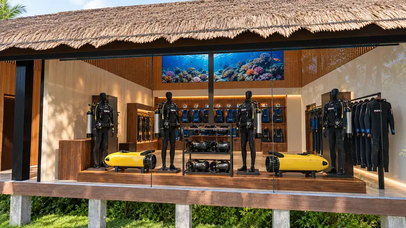 The gear showroom seen from the path: equipment and scooters